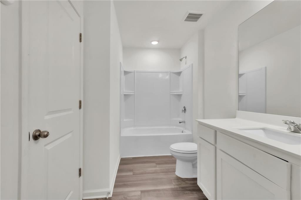 1517 Vernon Boulevard Decatur, GA 30035 - Photo 19 of 25 a bathroom with a sink a toilet and shower