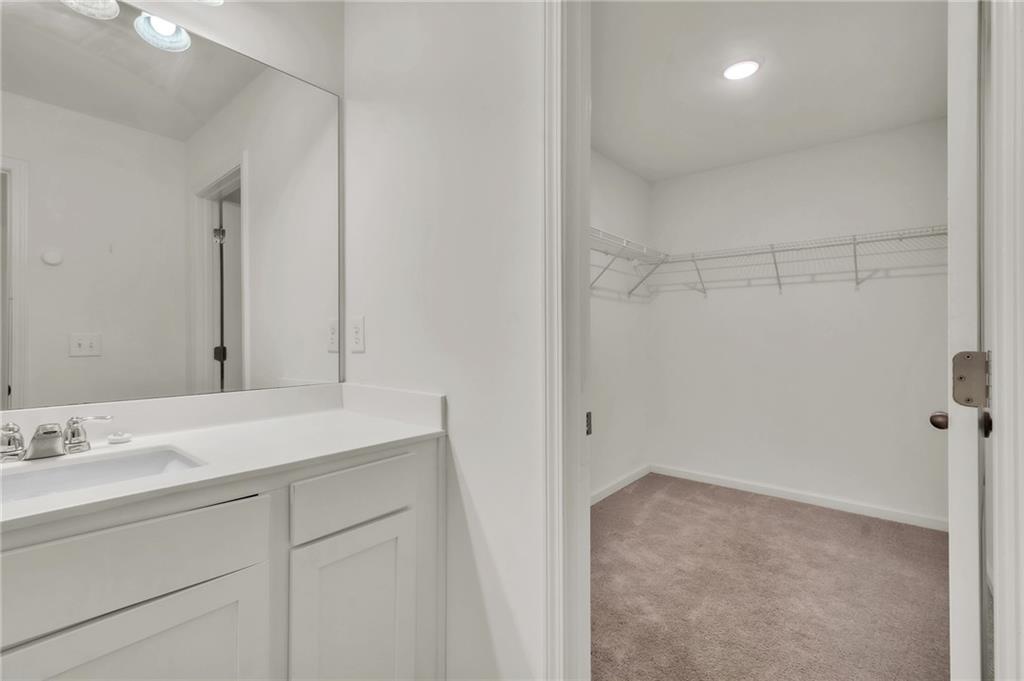 1517 Vernon Boulevard Decatur, GA 30035 - Photo 20 of 25 a bathroom with a sink vanity and a mirror