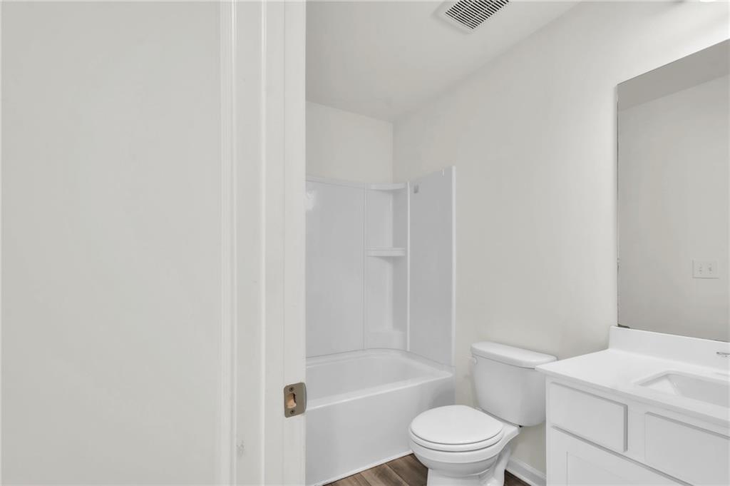 1517 Vernon Boulevard Decatur, GA 30035 - Photo 22 of 25 a bathroom with a toilet a sink and a shower