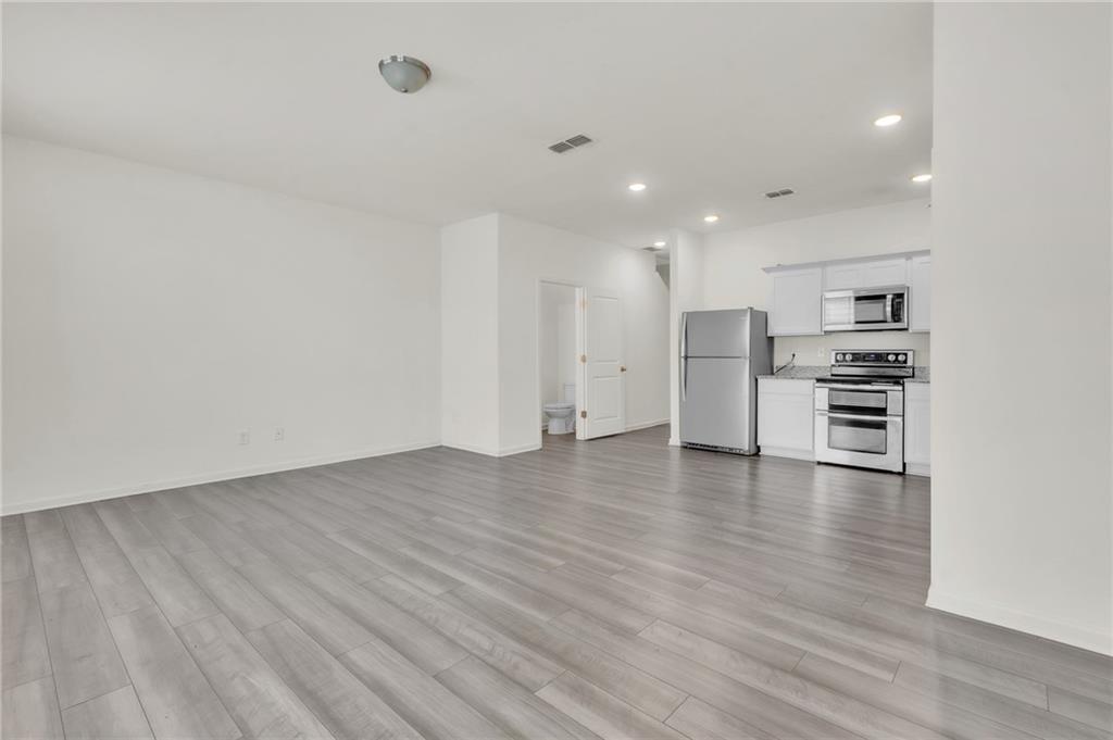1517 Vernon Boulevard Decatur, GA 30035 - Photo 5 of 25 a view of kitchen with refrigerator and wooden floor