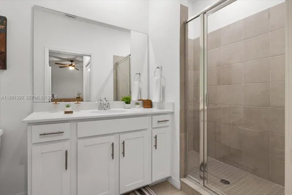 a bathroom with a shower sink and mirror