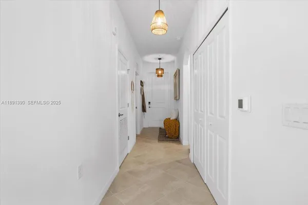 a view of a hallway with a dining room
