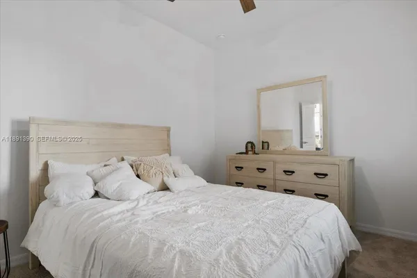 a bedroom with a bed and a mirror