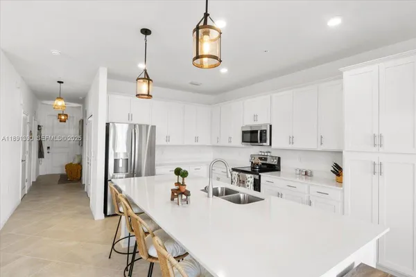 a kitchen with a sink a stove and refrigerator