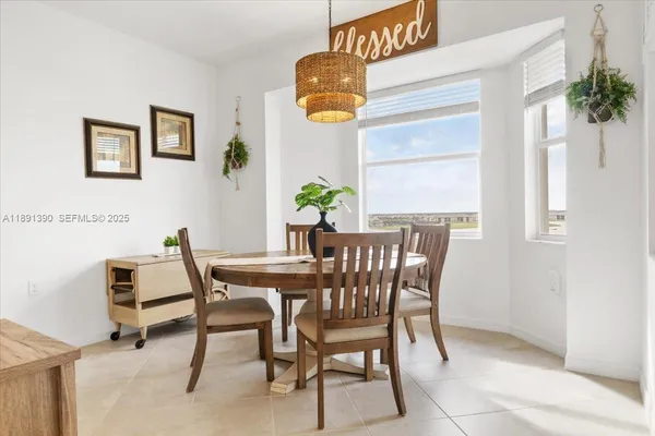 a view of a dining room with furniture and window