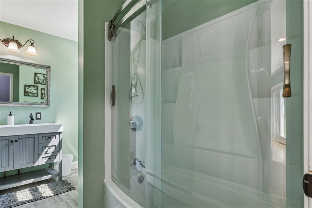 19 Cross Road Boxford, MA 01921 - Photo 11 of 41 a bathroom with a sink a toilet and shower