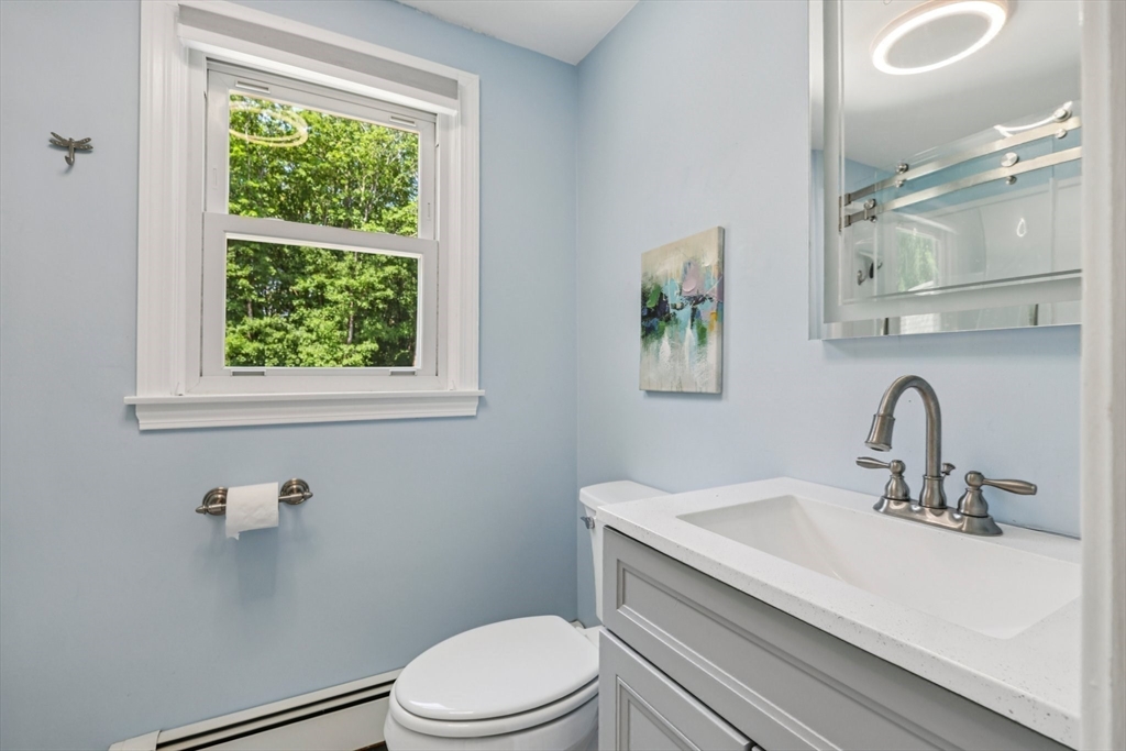 19 Cross Road Boxford, MA 01921 - Photo 13 of 41 a bathroom with a sink a toilet and a window