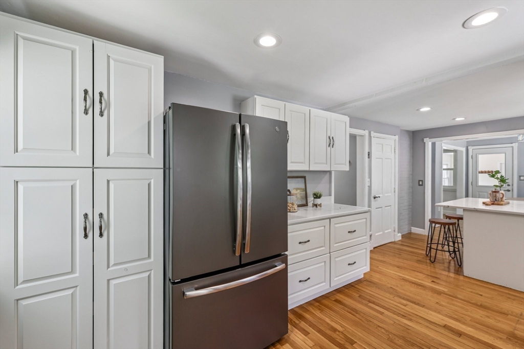 19 Cross Road Boxford, MA 01921 - Photo 20 of 41 a kitchen with white cabinets and stainless steel appliances