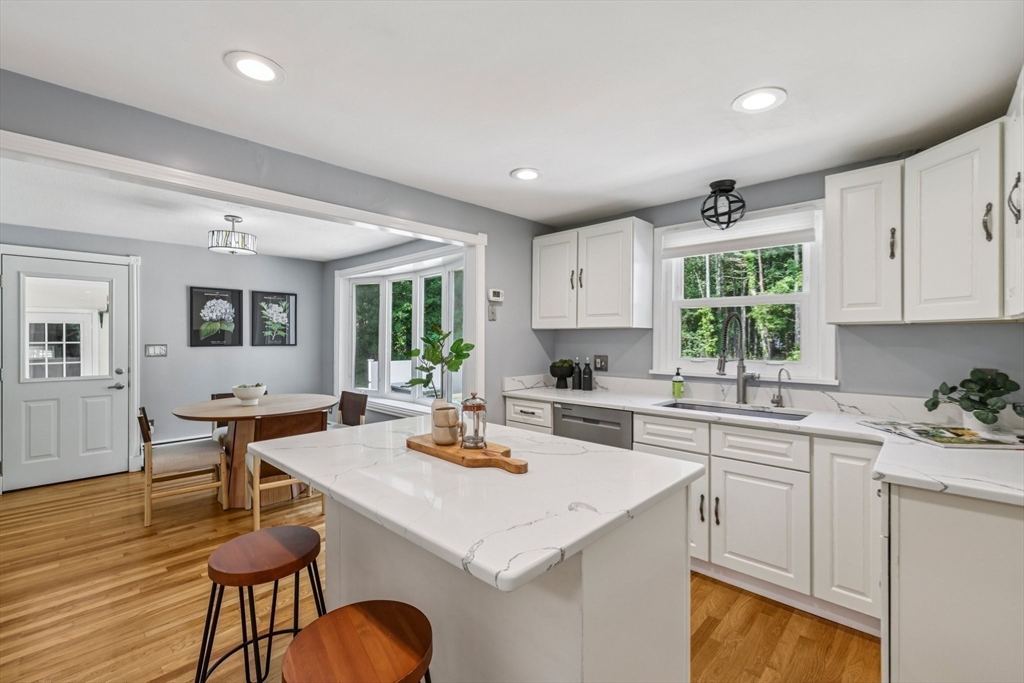 19 Cross Road Boxford, MA 01921 - Photo 23 of 41 a kitchen with a sink a stove cabinets dining table and chairs