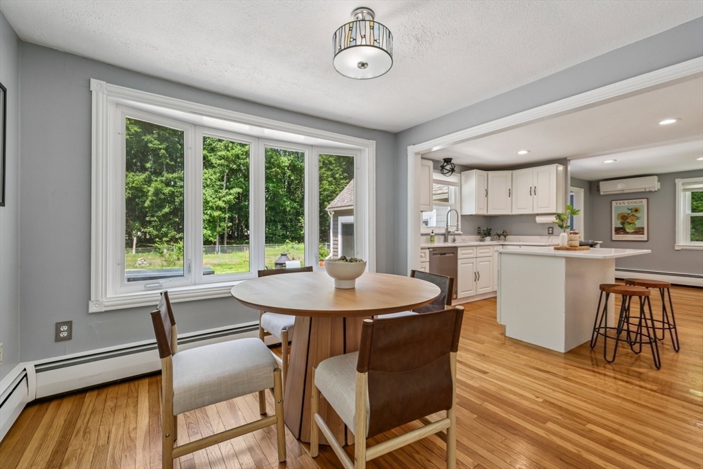 19 Cross Road Boxford, MA 01921 - Photo 25 of 41 a dining room with a table chairs and a kitchen view