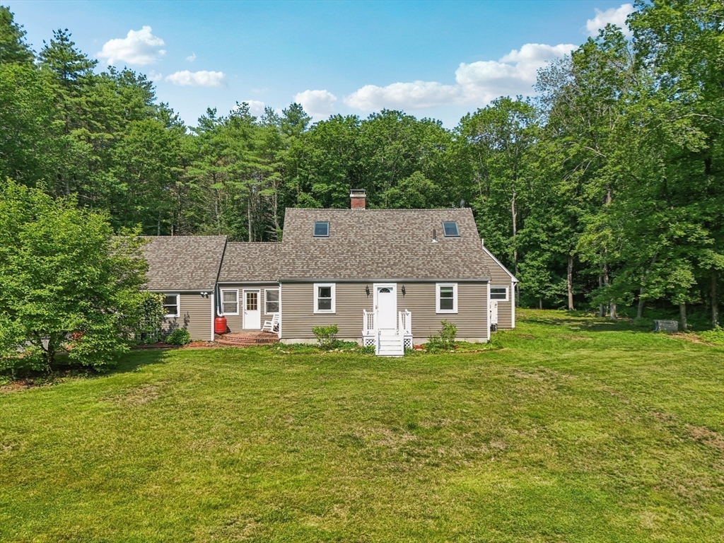 19 Cross Road Boxford, MA 01921 - Photo 35 of 41 a house that is sitting in the grass with large trees