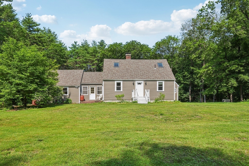 19 Cross Road Boxford, MA 01921 - Photo 37 of 41 a house that is sitting in the grass with large trees
