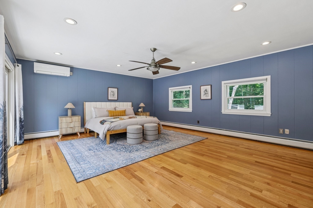 19 Cross Road Boxford, MA 01921 - Photo 10 of 41 a bedroom with a bed and a chandelier