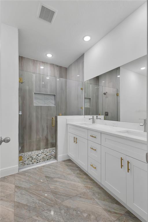 1425 River Road St. Cloud, FL 34769 - Photo 20 of 32 a spacious bathroom with a shower a sink and a mirror