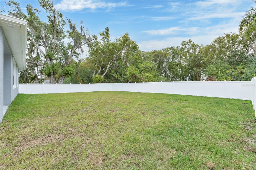 1425 River Road St. Cloud, FL 34769 - Photo 22 of 32 a view of yard with trees in the background