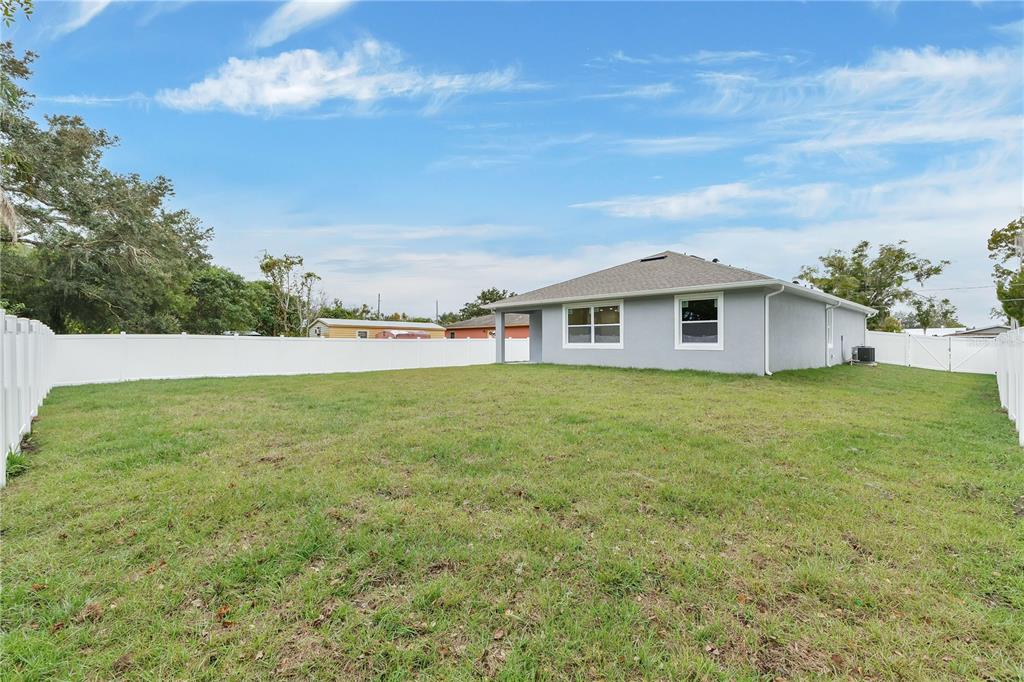 1425 River Road St. Cloud, FL 34769 - Photo 24 of 32 a view of house with backyard and entertaining space