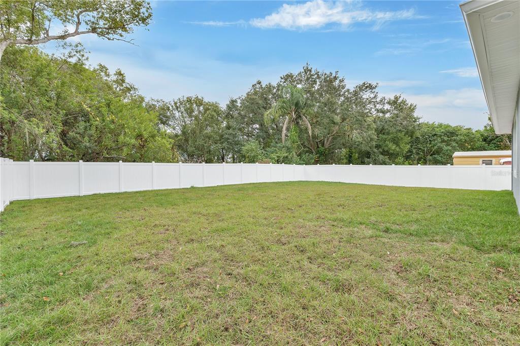 1425 River Road St. Cloud, FL 34769 - Photo 25 of 32 a view of yard with trees in the background