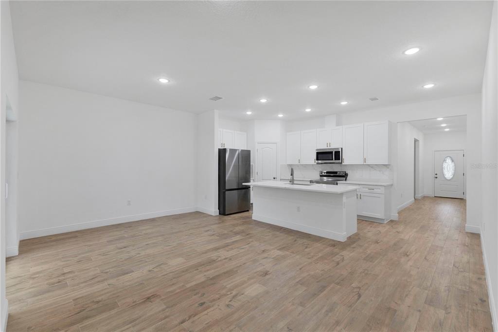 1425 River Road St. Cloud, FL 34769 - Photo 3 of 32 a large kitchen with a refrigerator and a stove top oven