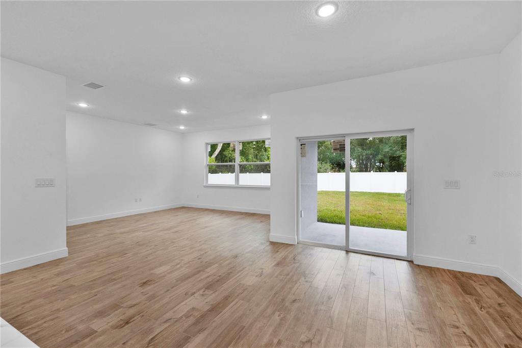1425 River Road St. Cloud, FL 34769 - Photo 5 of 32 wooden floor in an empty room with a window