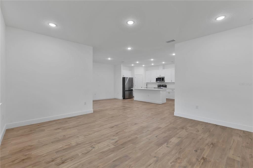 1425 River Road St. Cloud, FL 34769 - Photo 6 of 32 a view of a kitchen with a sink and a refrigerator
