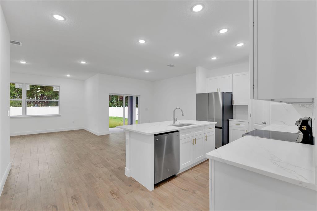 1425 River Road St. Cloud, FL 34769 - Photo 8 of 32 a kitchen with white cabinets and sink