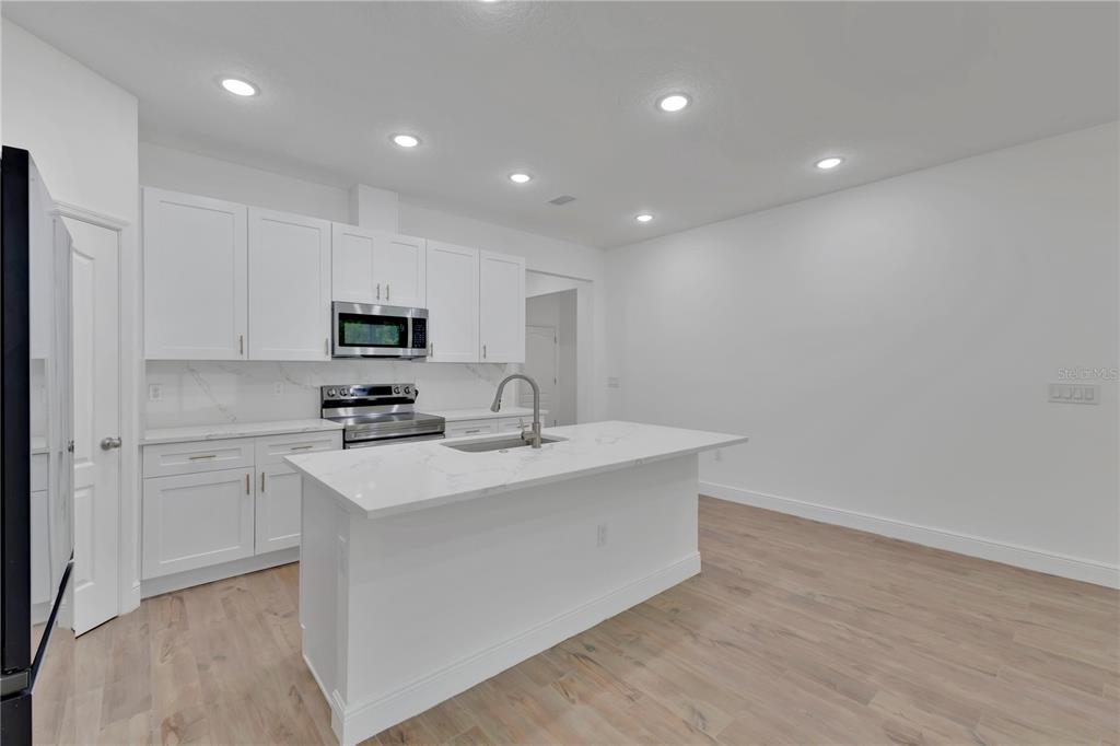 1425 River Road St. Cloud, FL 34769 - Photo 10 of 32 a kitchen with appliances a sink and cabinets