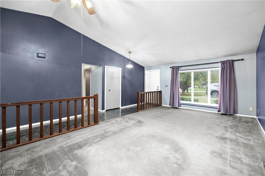 18042 Howe Road Strongsville, OH 44136 - Photo 5 of 35 Carpeted empty room featuring ceiling fan and vaulted ceiling