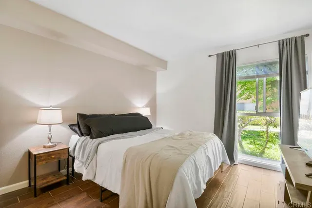 a bedroom with a bed and a flat screen tv