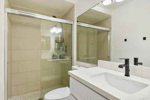 a view of a balcony with chair and wooden fence