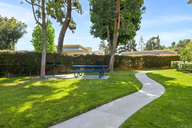 a view of a patio with a table and chairs under an umbrella
