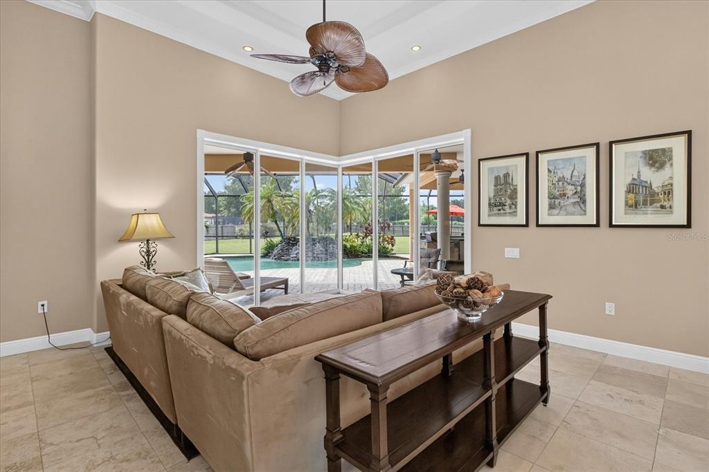 9427 Eddings Road Odessa, FL 33556 - Photo 11 of 93 a living room with furniture a flat screen tv and a large window