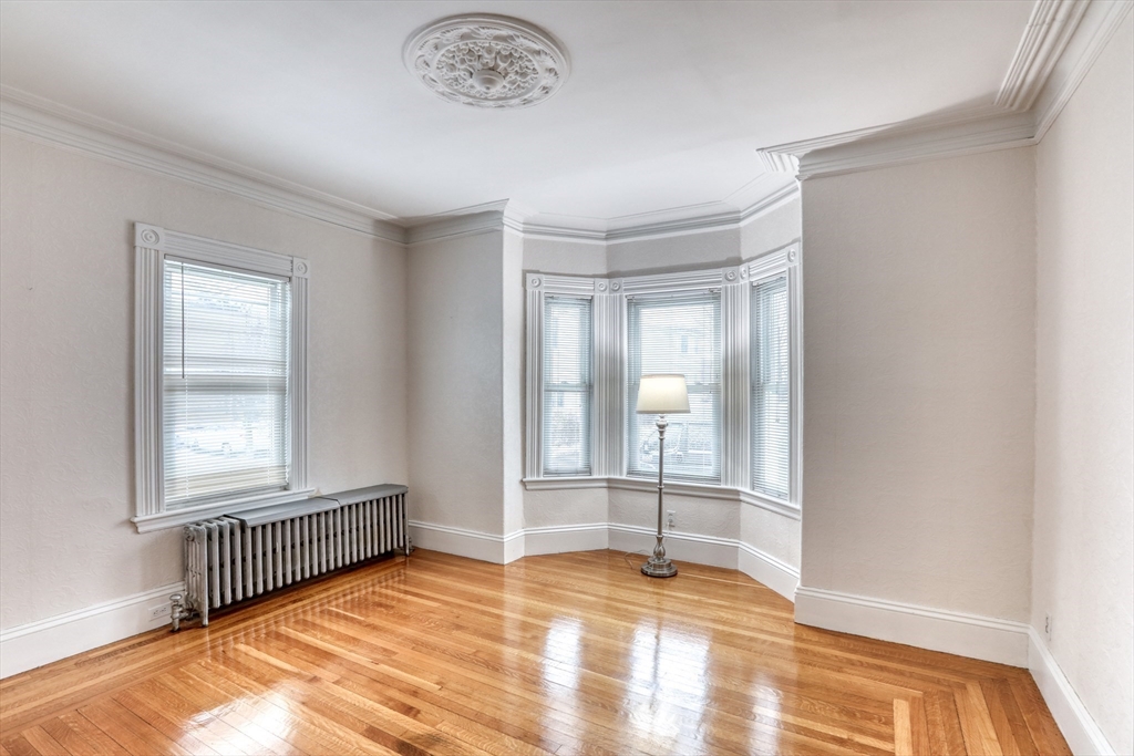 45 Read Street Winthrop, MA 02152 - Photo 11 of 30 an empty room with wooden floor and windows