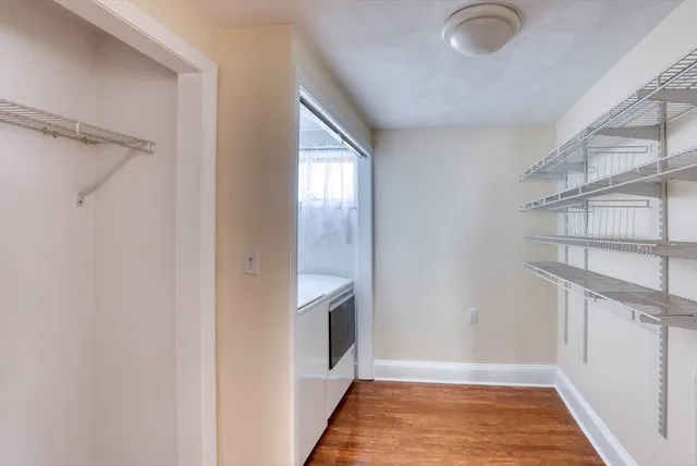 a view of an empty room with a fireplace and a window