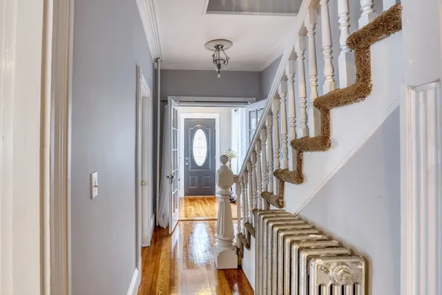 a view of staircase with railing and frames on wall
