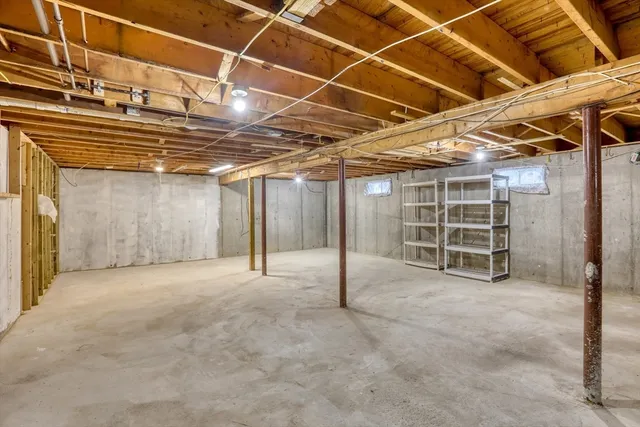a view of an empty room with white walls and a window