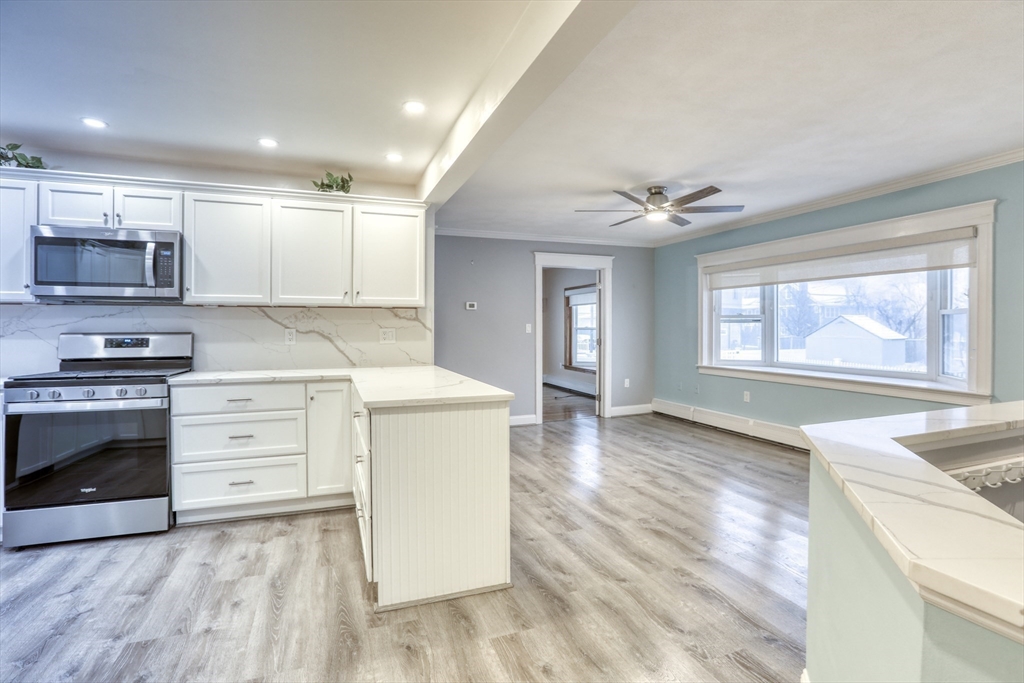 45 Read Street Winthrop, MA 02152 - Photo 4 of 30 a kitchen with a stove a sink and a microwave