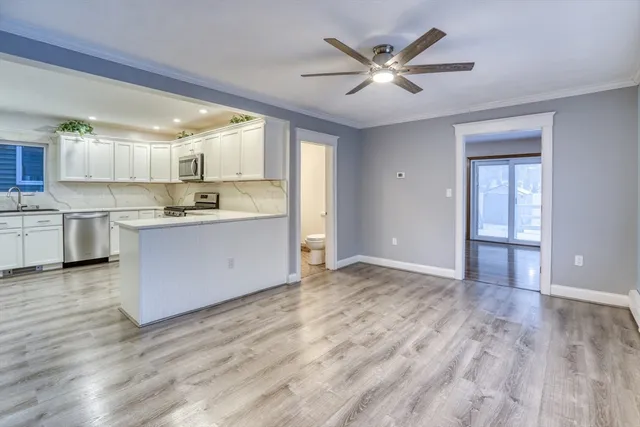 a view of kitchen with cabinets and wooden floor