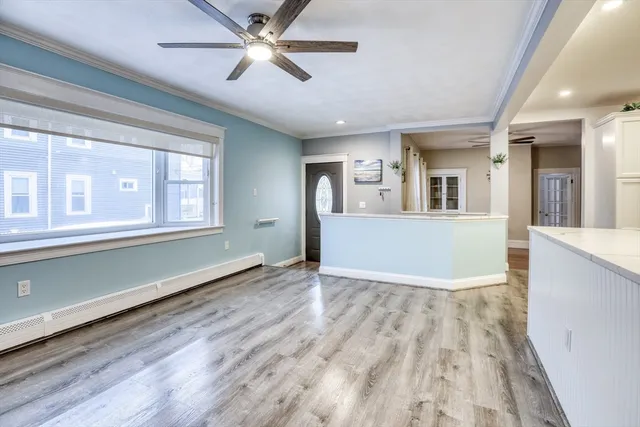 wooden floor in an empty room with a window