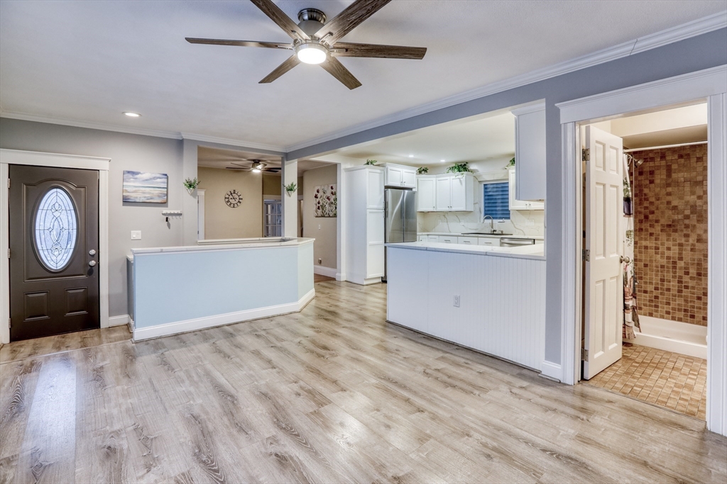 45 Read Street Winthrop, MA 02152 - Photo 7 of 30 a view of a kitchen with cabinets wooden floor and window