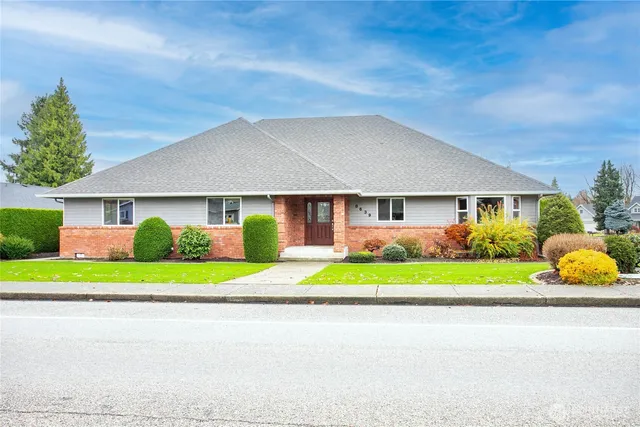 a front view of a house with a yard and porch