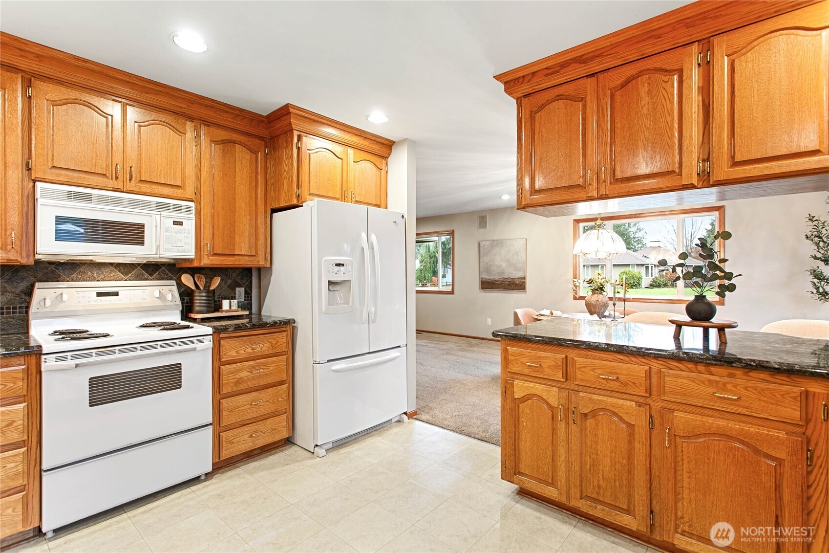8639 Bender Road Lynden, WA 98264 - Photo 17 of 40 a kitchen with granite countertop cabinets stainless steel appliances and a sink