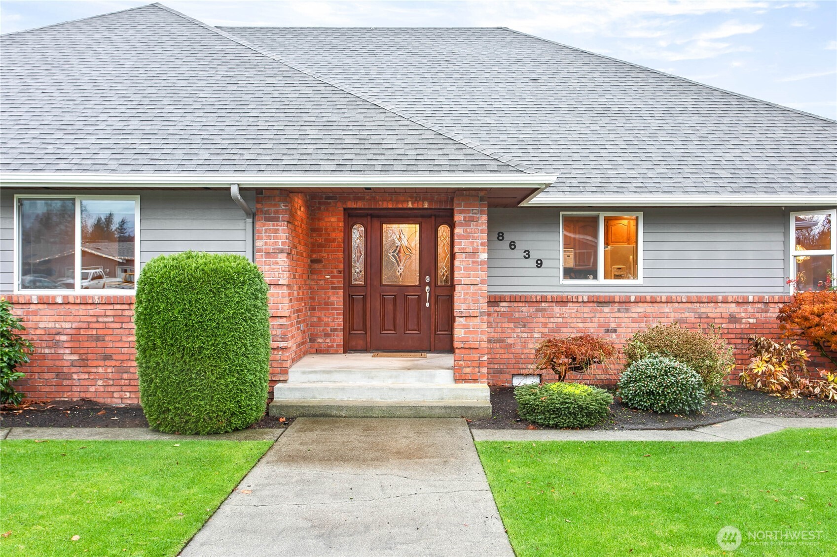 8639 Bender Road Lynden, WA 98264 - Photo 3 of 40 a front view of a house with a yard and garage