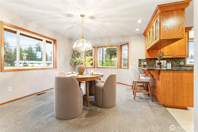 a view of a dining room with furniture window and outside view