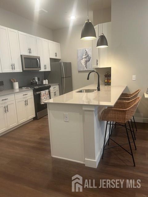 6202 Domzal Road, Unit 6202 Sayreville, NJ 08872 - Photo 2 of 12 a kitchen with stainless steel appliances granite countertop a stove a sink and a microwave