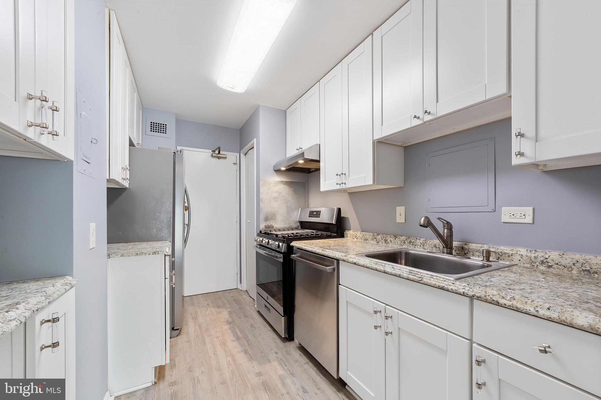 1900 Lyttonsville Road, Unit 111 Silver Spring, MD 20910 - Photo 11 of 21 a kitchen with stainless steel appliances granite countertop a refrigerator sink and stove