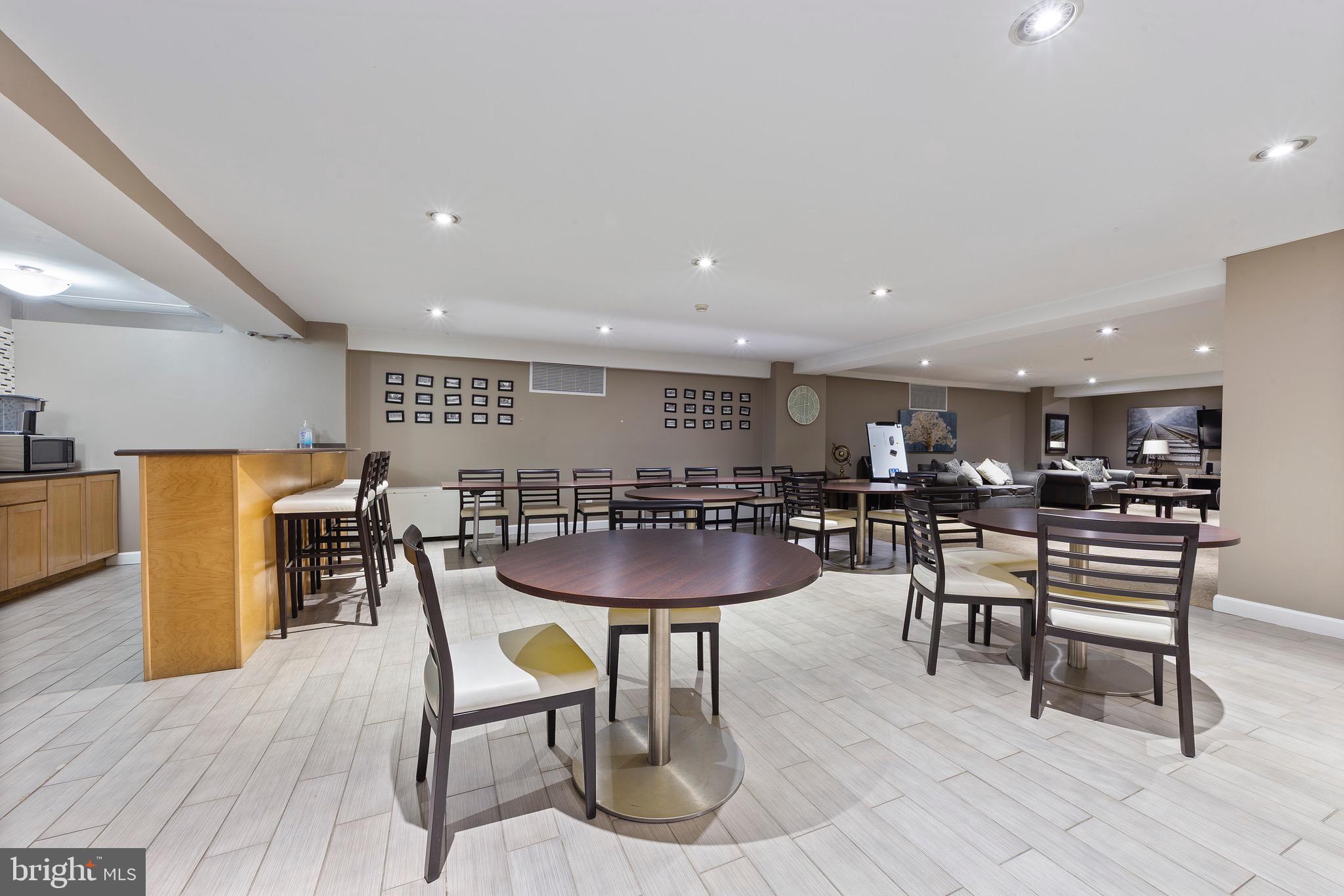1900 Lyttonsville Road, Unit 111 Silver Spring, MD 20910 - Photo 18 of 21 a view of a dining room with furniture and wooden floor