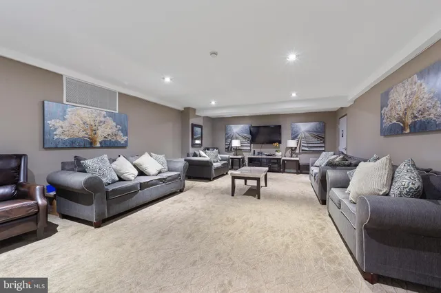 a lobby with furniture and potted plants