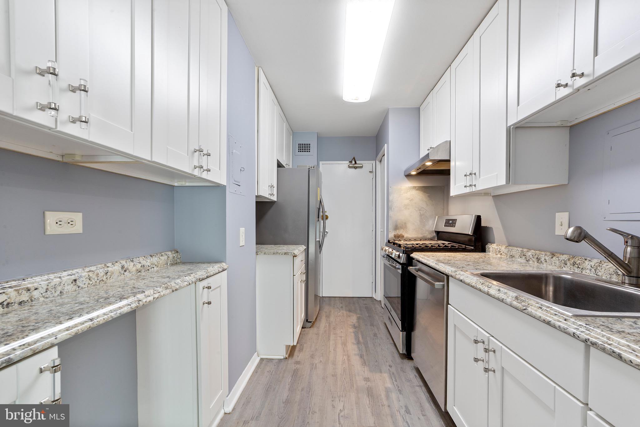 1900 Lyttonsville Road, Unit 111 Silver Spring, MD 20910 - Photo 3 of 21 a kitchen with a sink stove and refrigerator