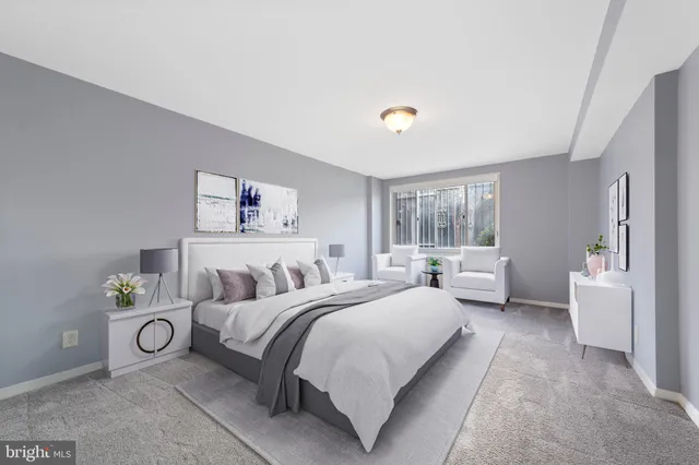 a bedroom with a bed and a couch