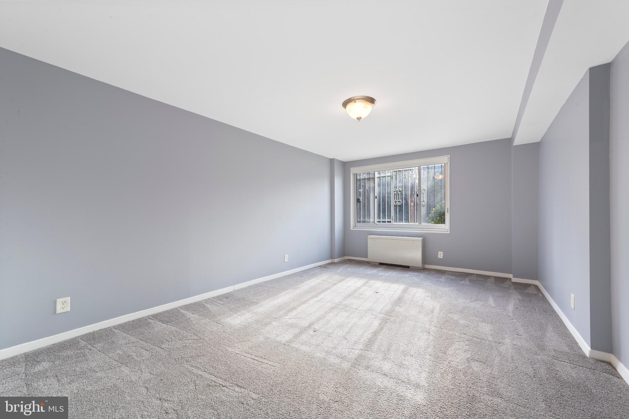 1900 Lyttonsville Road, Unit 111 Silver Spring, MD 20910 - Photo 7 of 21 a view of an empty room with a window